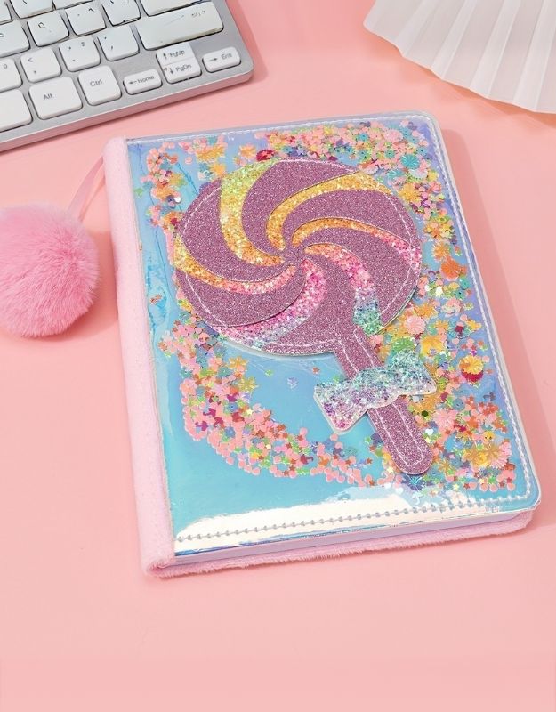 Colorful plush notebook with glittery lollipop design and pink pom-pom, perfect for girls' diaries or journaling.